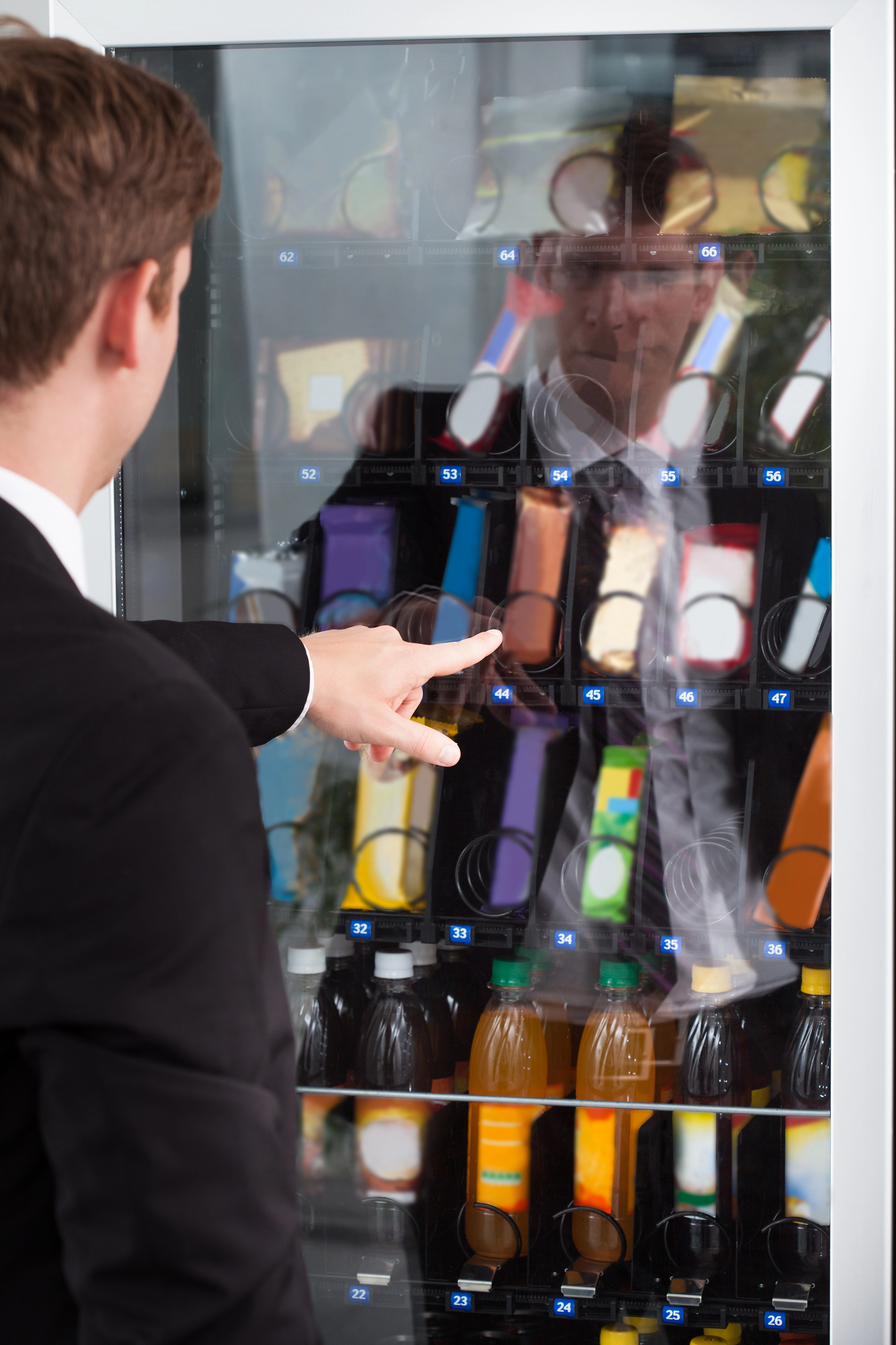 Choosing a snack from a fully stocked vending machine