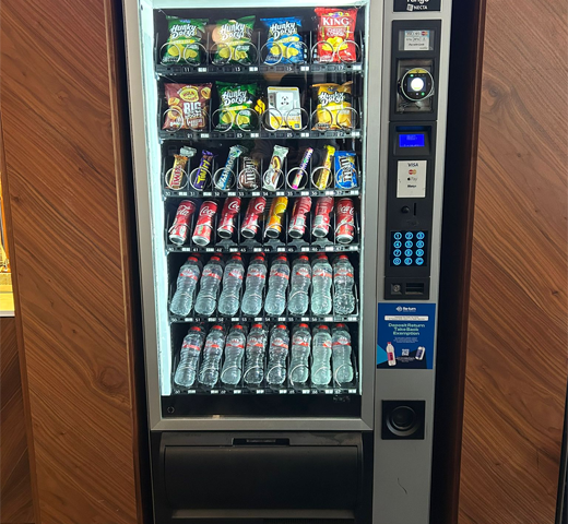Fully stocked vending machine with walnut surround