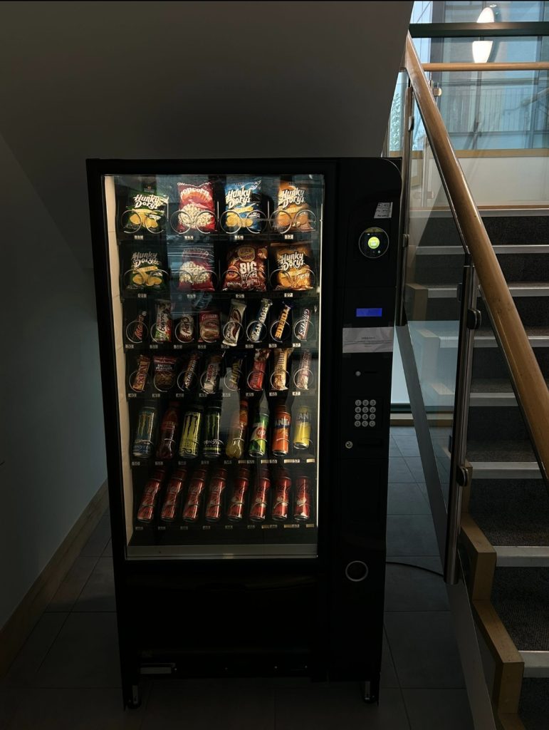 Vending machine in an office stairwell in evening light